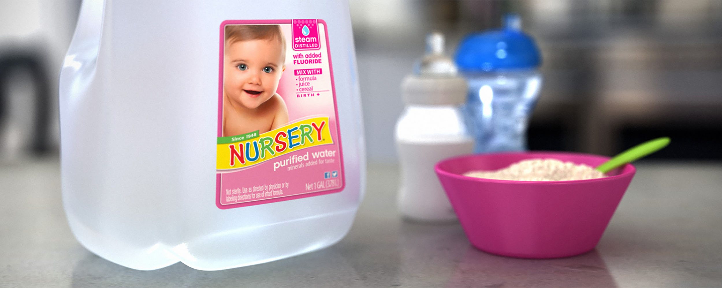 nursery water gallon next to bowl of porridge